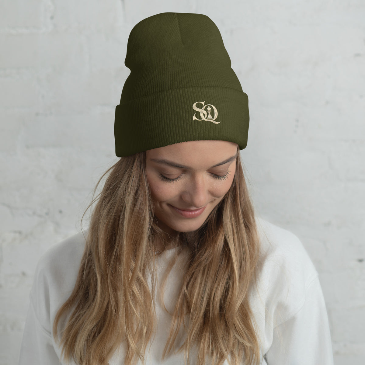 Olive cuffed beanie with gold embroidered SQ monogram, worn by model